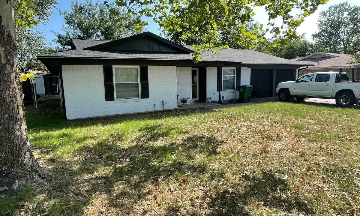 Professional roofing crew working on a residential roof in Grove